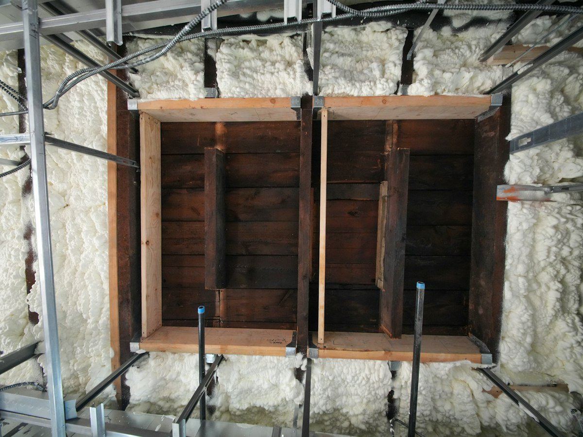 Spray foam insulation applied to a wood-framed wall